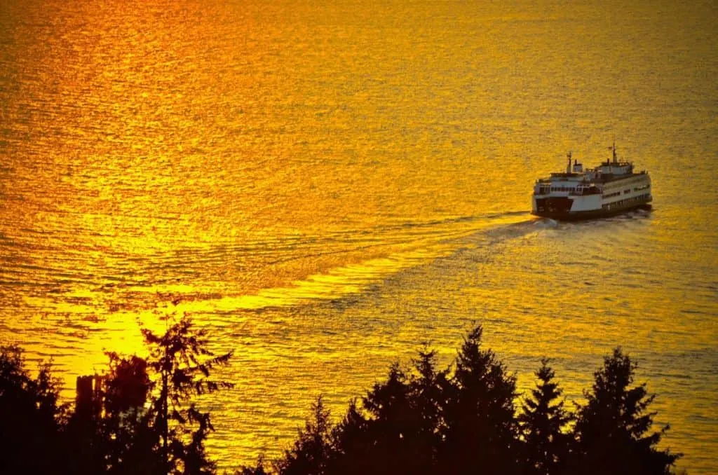A ferry on its way while the sun is setting