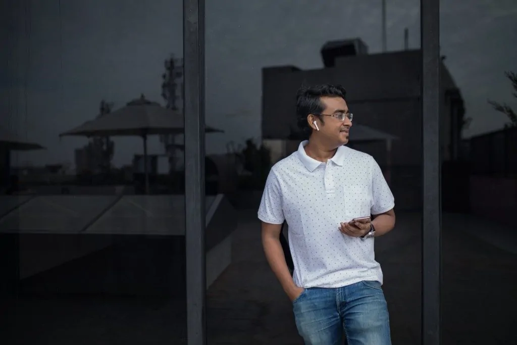 Man making a phone call with earpods in