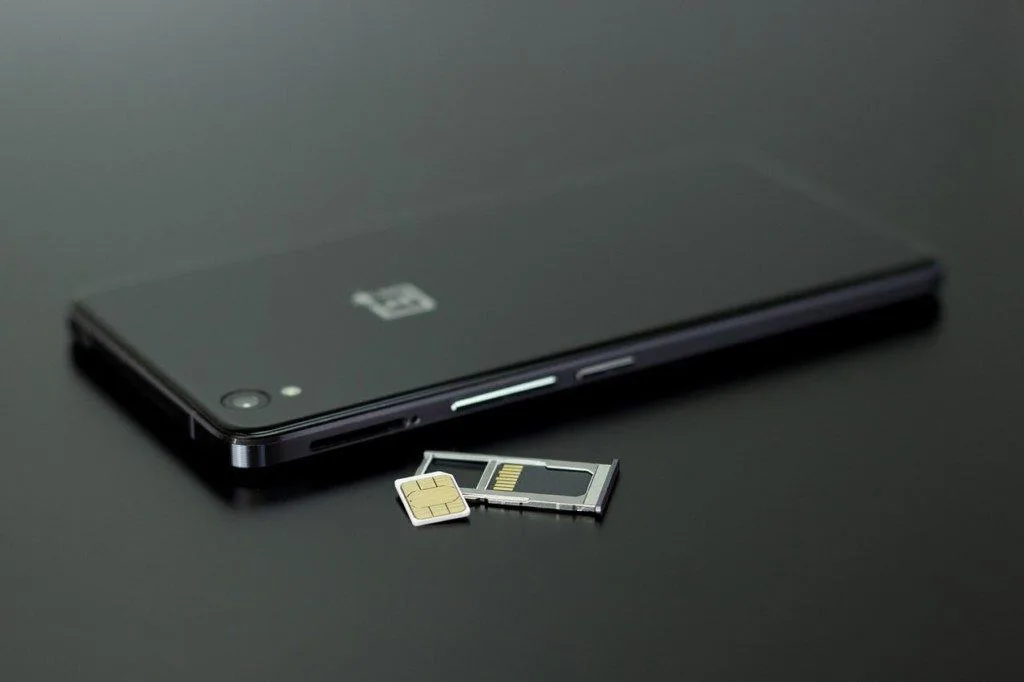 SIM card next to a OnePlus phone