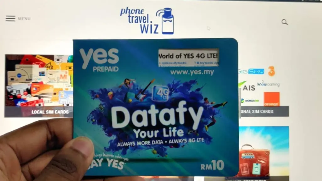Adu from Phone Travel Wiz holding a Yes SIM Card