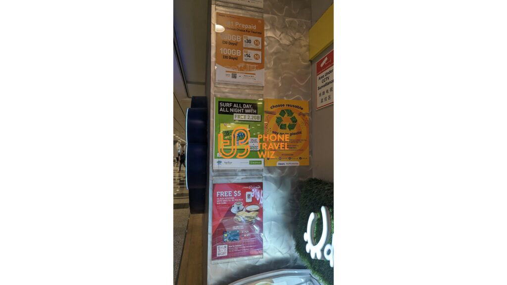 Cheers Convenience Store at Singapore Changi Airport with posters for Singtel, StarHub M1 Singapore Tourist SIM Cards