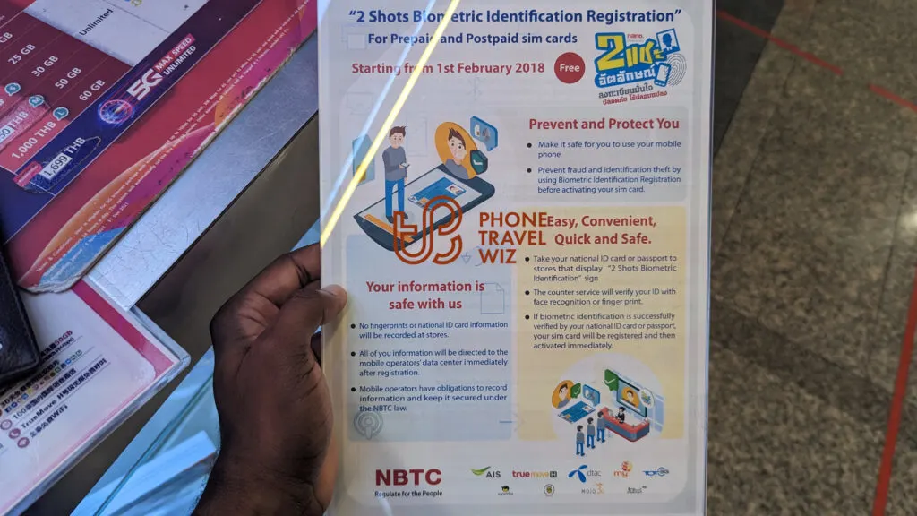 Adu from Phone Travel Wiz Holding a Flyer about Thailand's SIM Card Registration Process