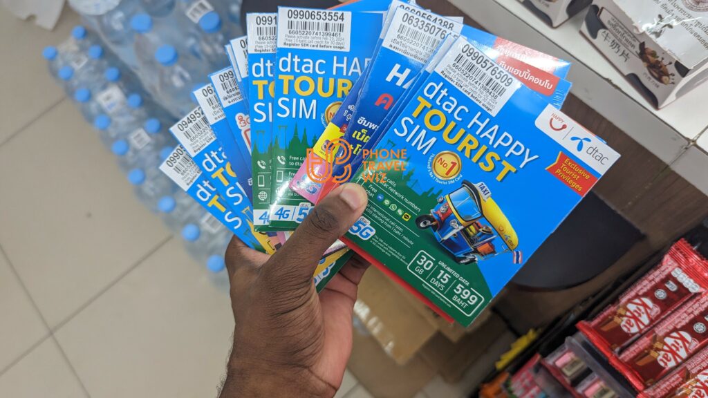 Adu from Phone Travel Wiz holding Dtac Thailand Tourist SIM Cards in a Familymart in Koh Samui